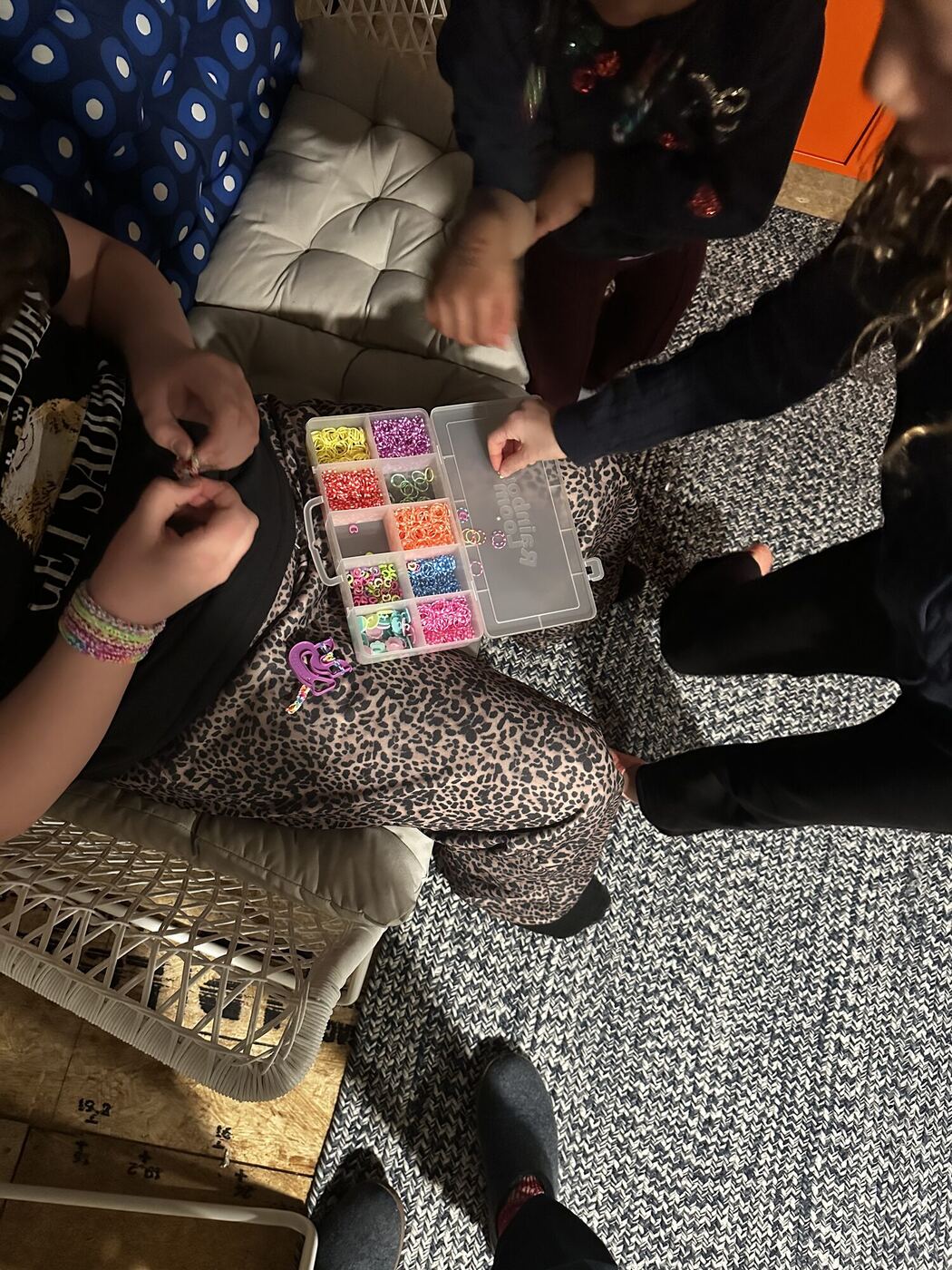 Hands and a box of colored beads