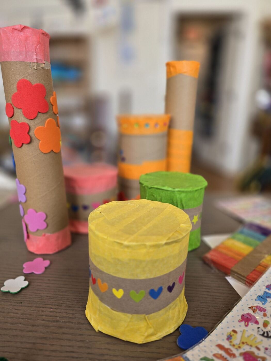 Cardboard tube shakers wrapped in tissue paper, foam flowers and heart stickers
